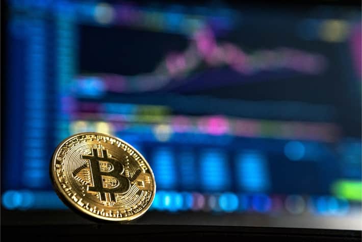Bitcoin in front of a laptop screen representing the ransom demanded in WannaCry ransomware attack Bitcoin in front of a laptop screen representing the ransom demanded in WannaCry ransomware attack