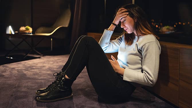 sad teenager with a smartphone