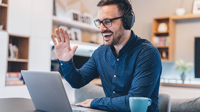 smiling man with glasses and laptop
