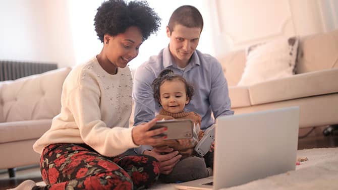 family with laptop and smartphone