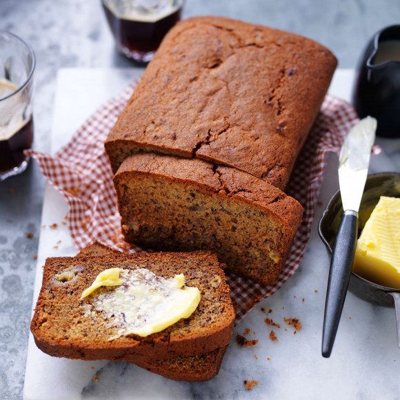 Classic banana bread recipe sliced with butter