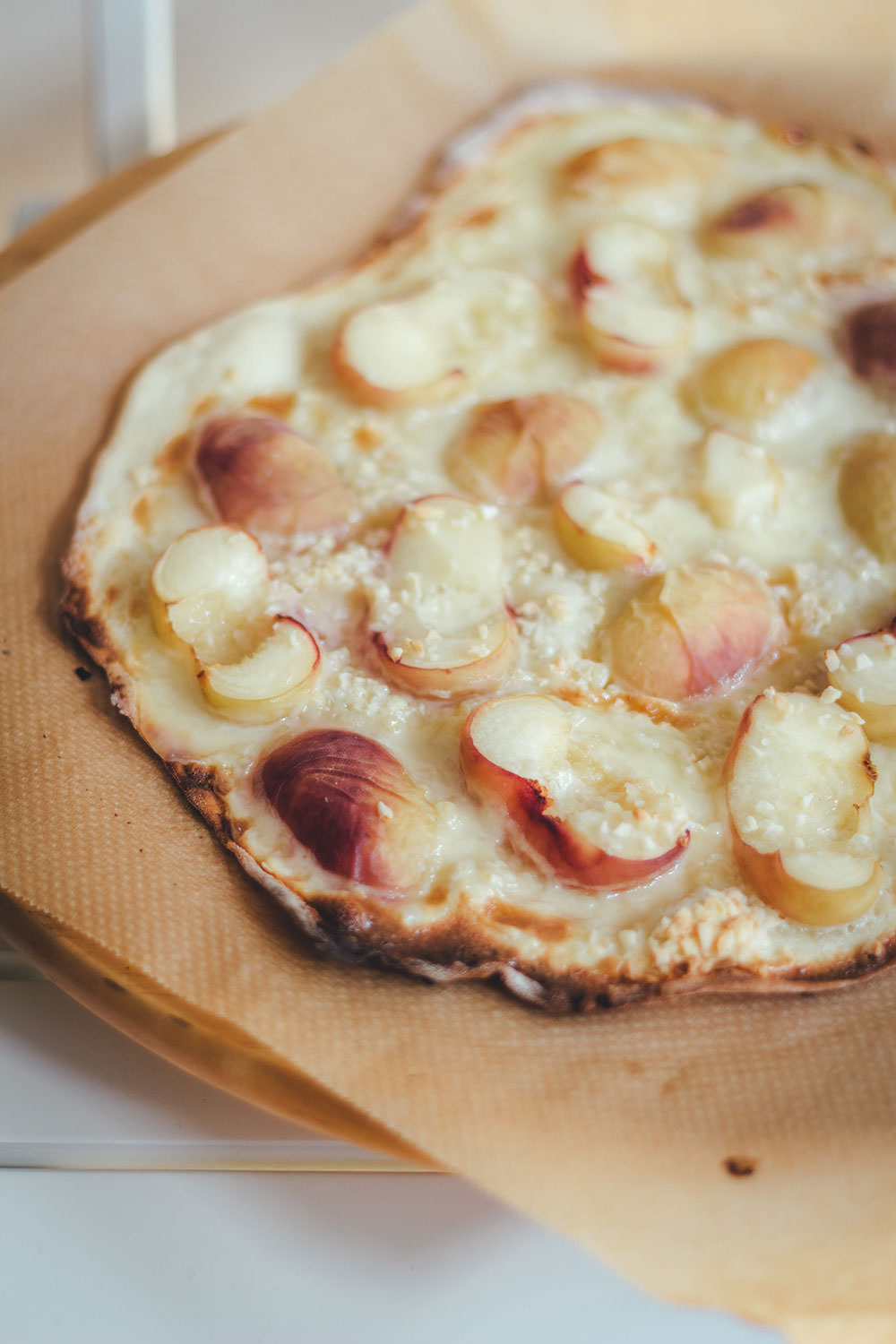 Rezept für sommerlichen Pfirsich-Flammkuchen mit Weinbergpfirsichen, Crème fraîche und Mandeln | moeyskitchen.com #flammkuchen #pfirsiche #weinbergpfirsich #mandeln #kuchenbacken #sommer #backen #rezepte #foodblogger