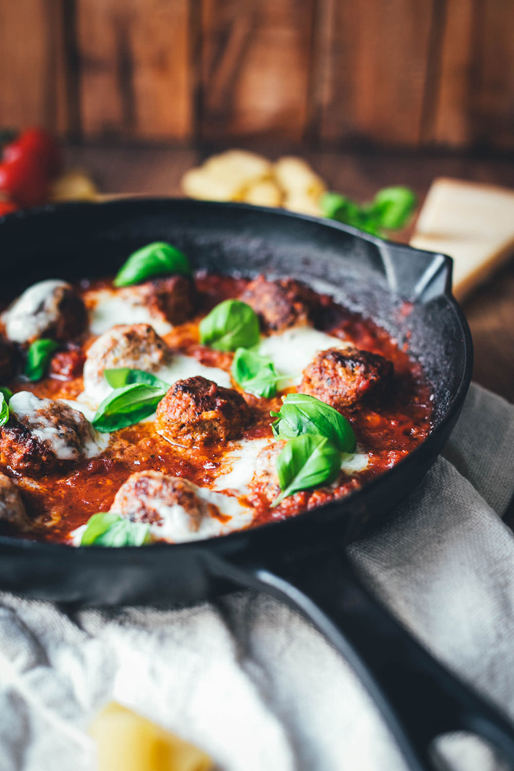 Rezept für den amerikanisch-italienischen Klassiker Baked Meatballs. Das sind saftige gratinierte Hackbällchen in Tomatensauce, die mit Mozzarella überbacken werden. Hier kennt man sie auch als "Hackbällchen Toskana". Sie schmecken fantastisch zu Pasta wie Spaghetti, Rigatoni oder auch einfach mit frischem, knusprigem Brot. | moeyskitchen.com
