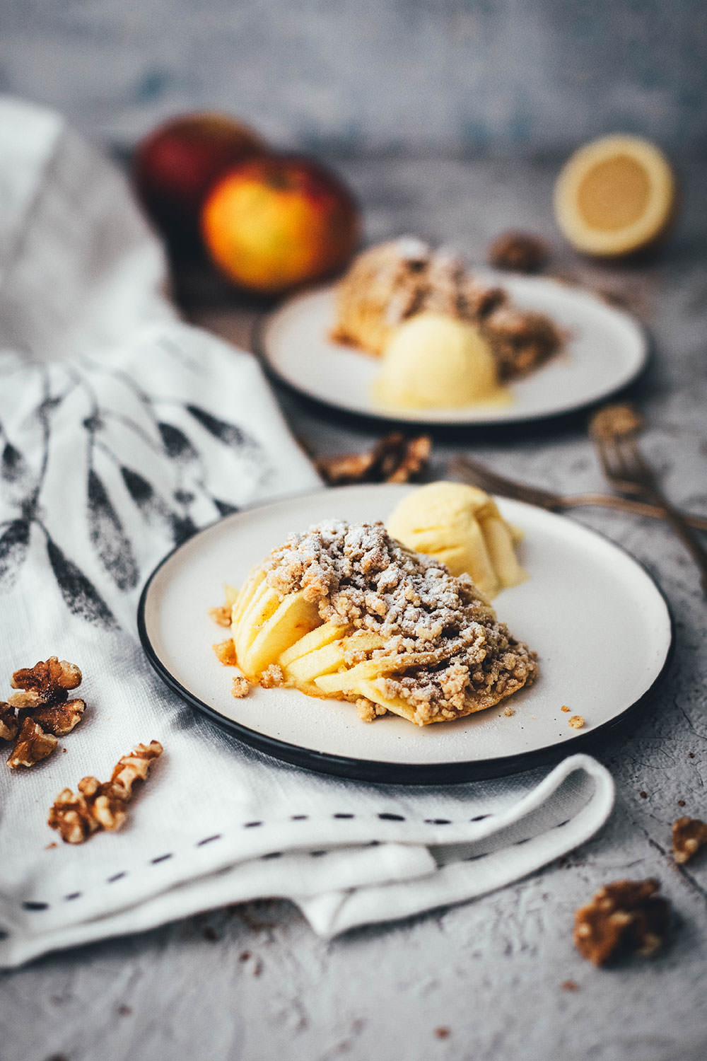 Wunderbare Rezeptidee für gebackene Äpfel mit Streuseln. Süßer Bratapfel trifft auf klassischen Apple Crumble oder Apple Crisp – heraus kommt mein Hasselback Bratapfel. Dafür werden halbierte Äpfel fächerförmig eingeschnitten, im Ofen gebacken und dann mit leckeren Streuseln bestreut. In diesen stecken gehackte Walnüsse und Haferflocken, das macht sie lecker und knusprig! | moeyskitchen.com